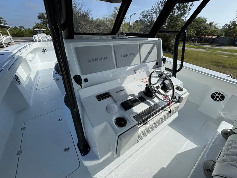 Slide: The Image of 2025 Invincible 46 Catamaran helm with Garmin displays and modern steering wheel. - 26