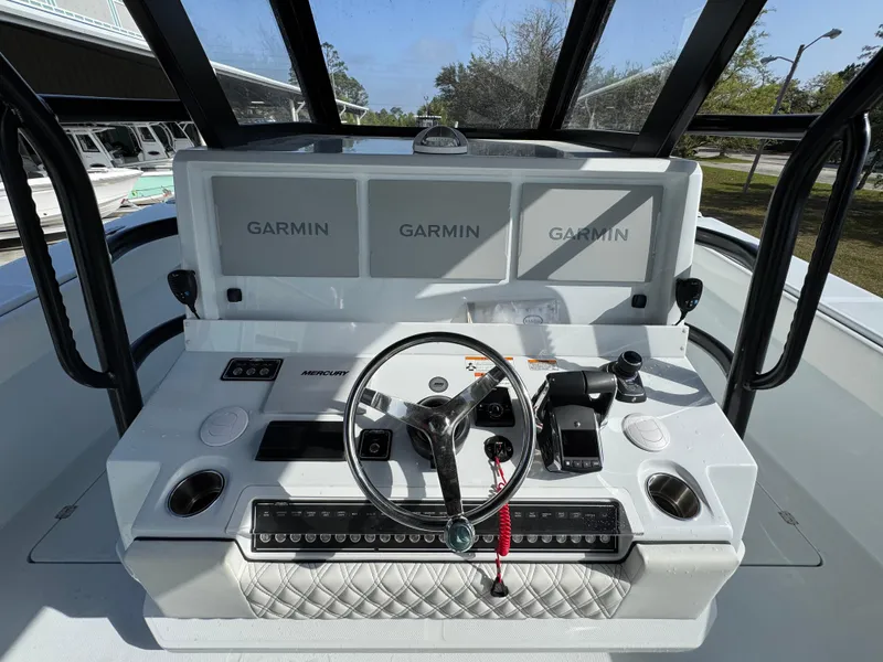 Slide: The Image of 2025 Invincible 46 Catamaran helm with Garmin displays and modern controls. - 27