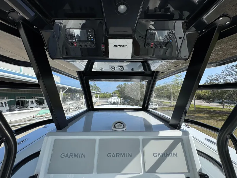Slide: The Image of 2025 Invincible 46 Catamaran cockpit with Garmin displays and Mercury controls. - 28