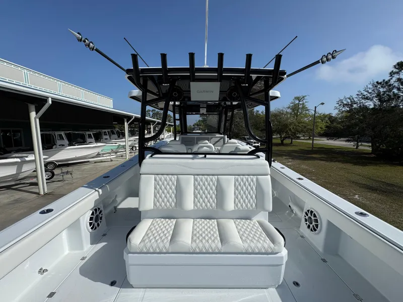 Slide: The Image of 2025 Invincible 46 Catamaran with white seating and rod holders, docked outdoors. - 35