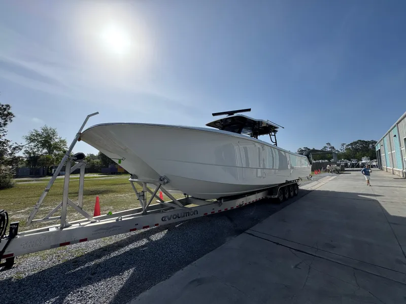 Slide: The Image of 2025 Invincible 46 Catamaran on trailer under bright sun, parked outdoors. - 5