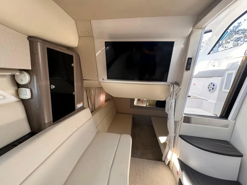 Slide: The Image of Interior of 2019 Regal 35 Sport Coupe with beige seating and mounted TV. - 15