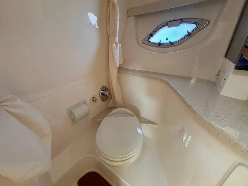 Slide: The Image of 2019 Regal 35 Sport Coupe bathroom with toilet, porthole, and countertop. - 18