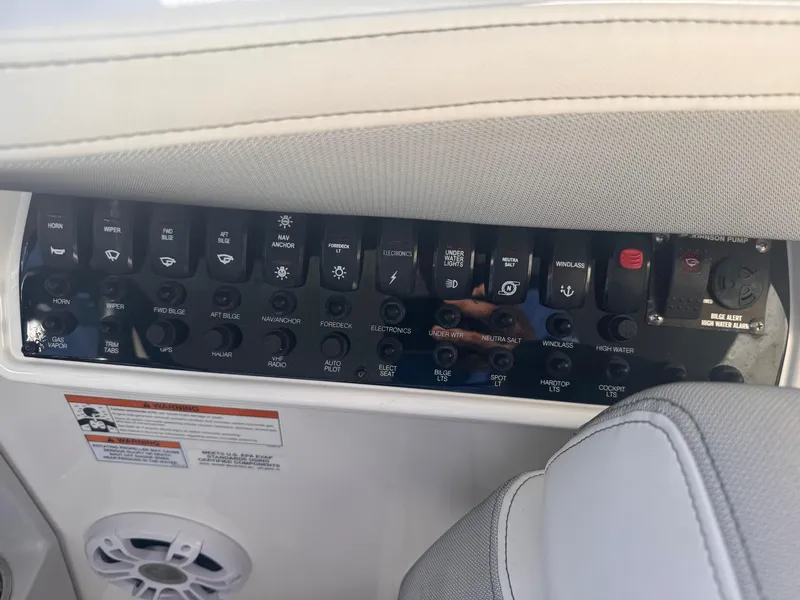 Slide: The Image of Control panel of a 2019 Regal 35 Sport Coupe boat with various switches and labels. - 20