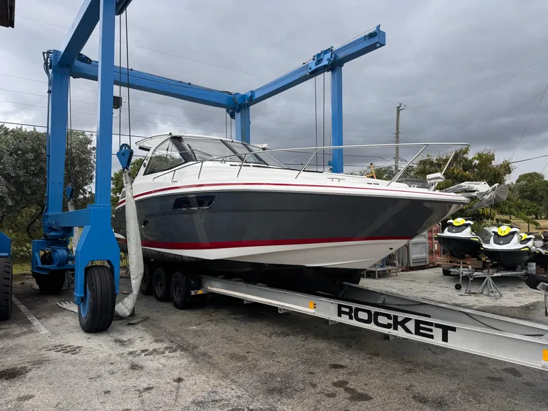 Slide: The Image of 2019 Regal 35 Sport Coupe on a trailer under a blue boat lift. - 4