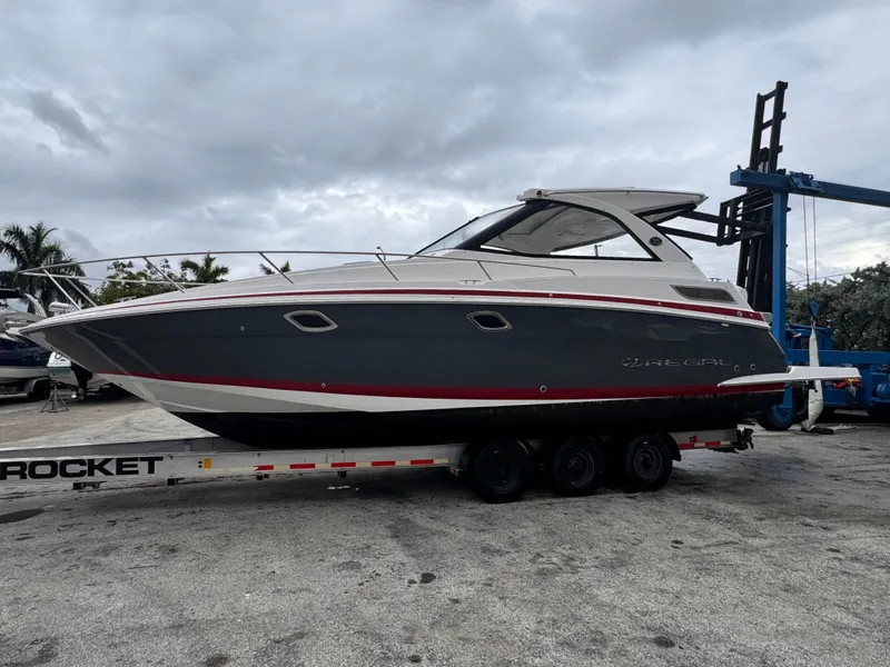 Slide: The Image of 2019 Regal 35 Sport Coupe boat on trailer, overcast sky background. - 6