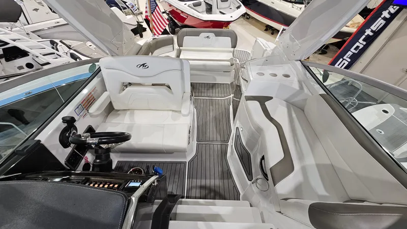 Slide: The Image of 2020 Monterey 295 Sport Yacht interior with white seating and modern helm. - 10