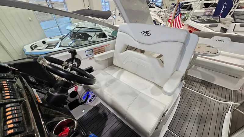 Slide: The Image of 2020 Monterey 295 Sport Yacht interior with white seating and steering wheel. - 17
