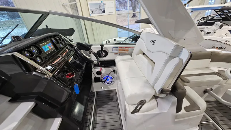 Slide: The Image of 2020 Monterey 295 Sport Yacht interior with modern dashboard and white seating. - 18