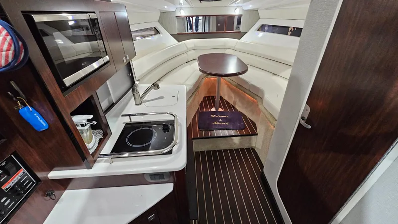 Slide: The Image of Interior of 2020 Monterey 295 Sport Yacht with kitchenette and seating area. - 24