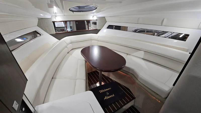 Slide: The Image of Interior of 2020 Monterey 295 Sport Yacht with elegant seating and wooden table. - 25