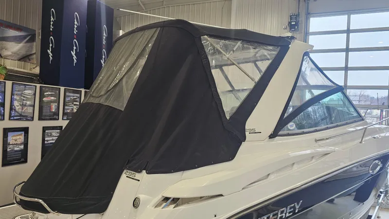 Slide: The Image of 2020 Monterey 295 Sport Yacht with black canopy in showroom. - 37
