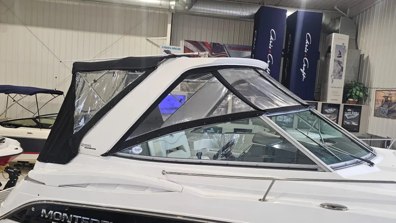 Slide: The Image of 2020 Monterey 295 Sport Yacht in showroom, featuring sleek design and black canopy. - 38