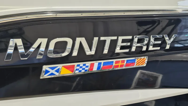 Slide: The Image of Monterey 295 Sport Yacht 2020 logo with nautical flags on black hull. - 40