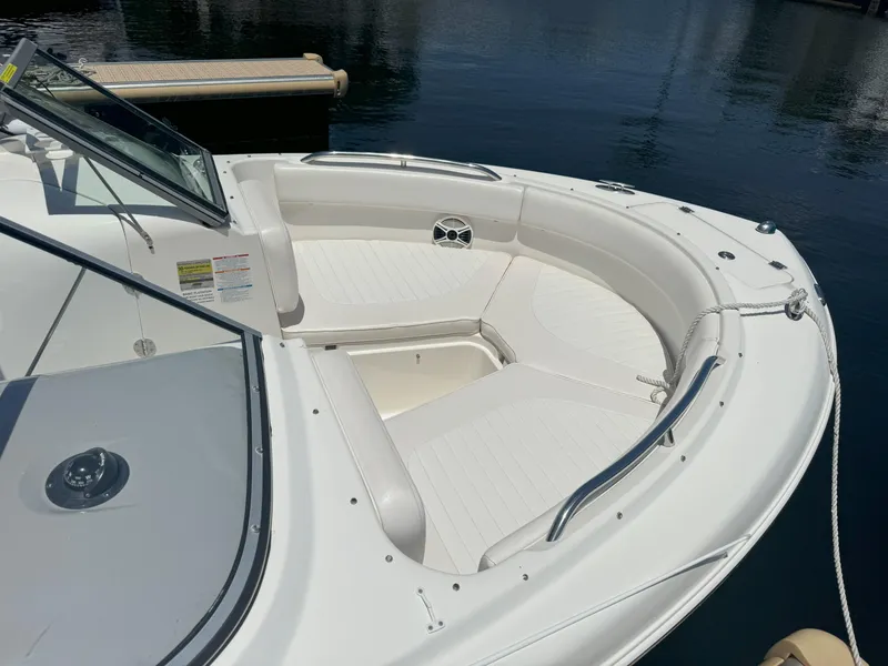 Slide: The Image of 2009 Robalo R227 Dual Console boat with spacious seating, docked on calm water. - 11