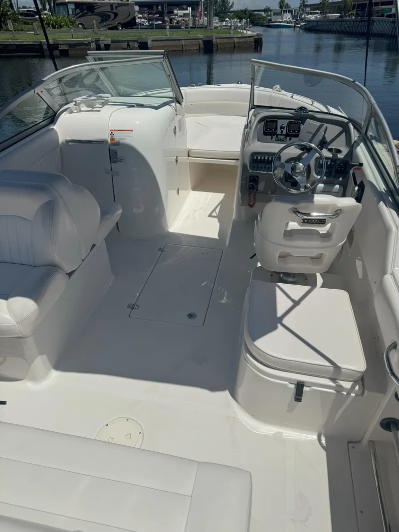 Slide: The Image of 2009 Robalo R227 Dual Console boat interior with seating and steering wheel. - 8