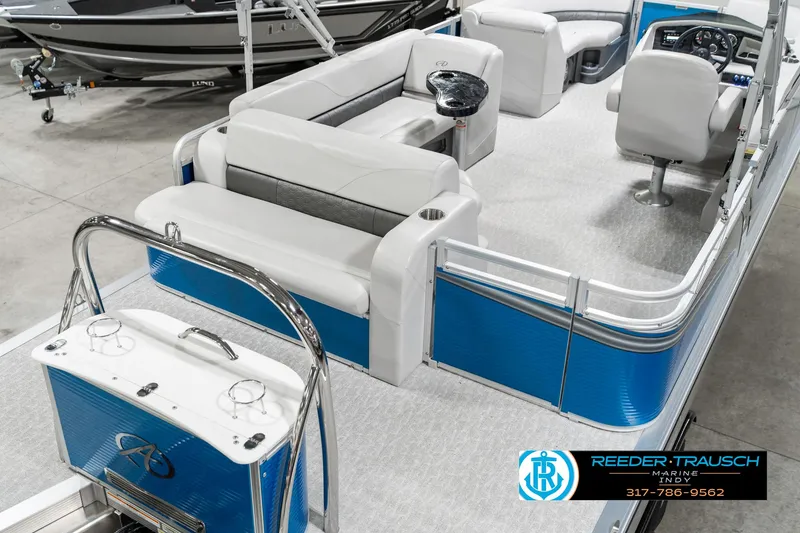 Slide: The Image of 2025 Avalon 2285 LSZ CRB pontoon boat interior with blue accents and seating arrangement. - 14