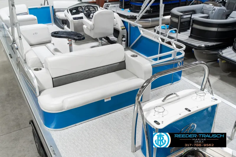 Slide: The Image of 2025 Avalon 2285 LSZ CRB pontoon boat with white and blue seating, showcased indoors. - 15