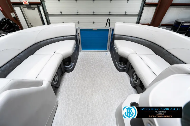 Slide: The Image of 2025 Avalon 2285 LSZ CRB boat interior with white seating and blue accents. - 21