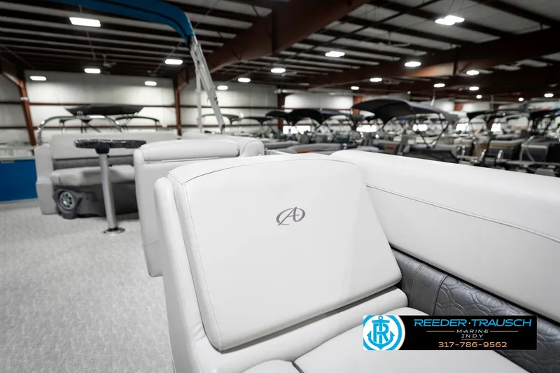 Slide: The Image of 2025 Avalon 2285 LSZ CRB pontoon boat interior in showroom, featuring luxurious seating. - 23