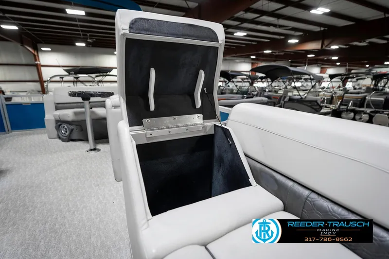 Slide: The Image of 2025 Avalon 2285 LSZ CRB boat interior with open storage compartment in showroom. - 24