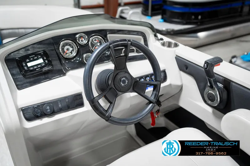 Slide: The Image of 2025 Avalon 2285 LSZ CRB boat dashboard with steering wheel and control panel. - 34