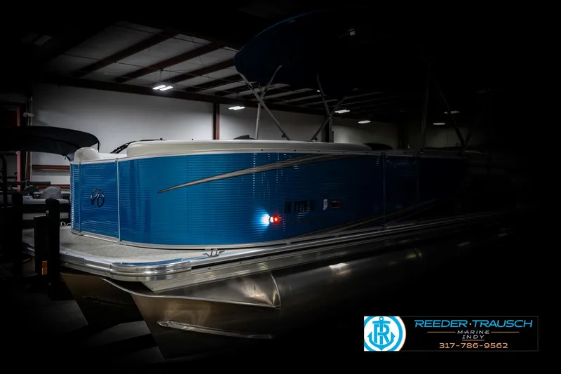 Slide: The Image of 2025 Avalon 2285 LSZ CRB pontoon boat in a dimly lit showroom. - 4