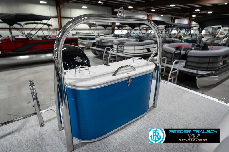 Slide: The Image of 2025 Avalon 2285 LSZ CRB pontoon boat with blue cooler, displayed indoors. - 49