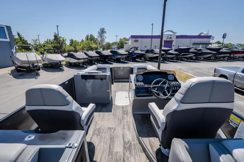 Slide: The Image of 2021 Godfrey Sanpan 2400 ULC pontoon boat interior at dealership, showcasing helm and seating. - 15