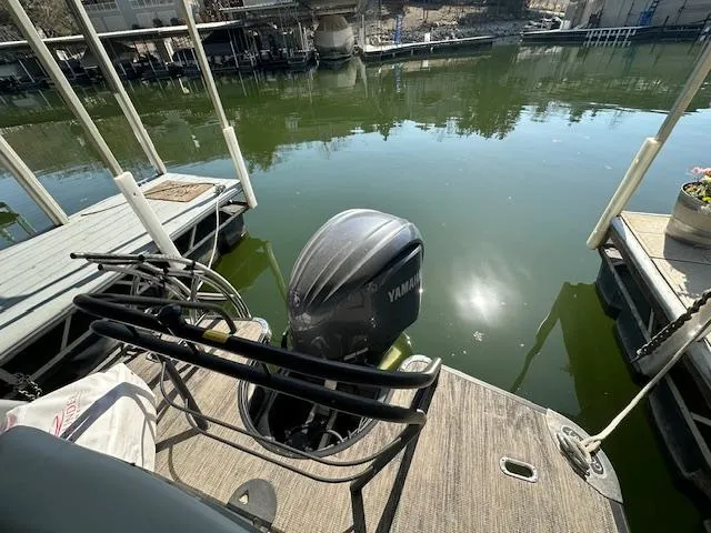 Slide: The Image of 2021 Godfrey Sanpan 2400 ULC pontoon boat with Yamaha outboard motor docked on calm water. - 11