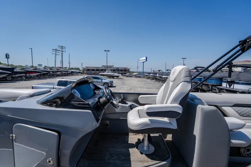 Slide: The Image of 2021 Godfrey Sanpan 2400 ULC pontoon boat interior with captain's chair and dashboard. - 30