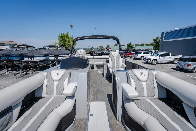 Slide: The Image of 2021 Godfrey Sanpan 2400 ULC pontoon boat with luxurious seating in a dealership lot. - 28