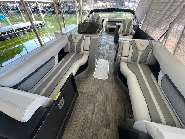 Slide: The Image of Luxurious 2021 Godfrey Sanpan 2400 ULC pontoon boat interior with plush seating and elegant design. - 7