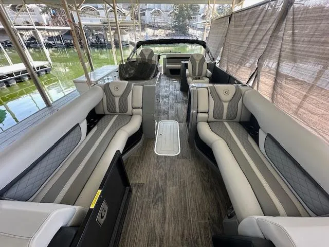 Slide: The Image of 2021 Godfrey Sanpan 2400 ULC pontoon boat interior with luxurious seating and wood-style flooring. - 8