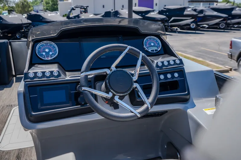 Slide: The Image of Steering console of 2021 Godfrey Sanpan 2400 ULC pontoon boat, featuring modern controls and gauges. - 18