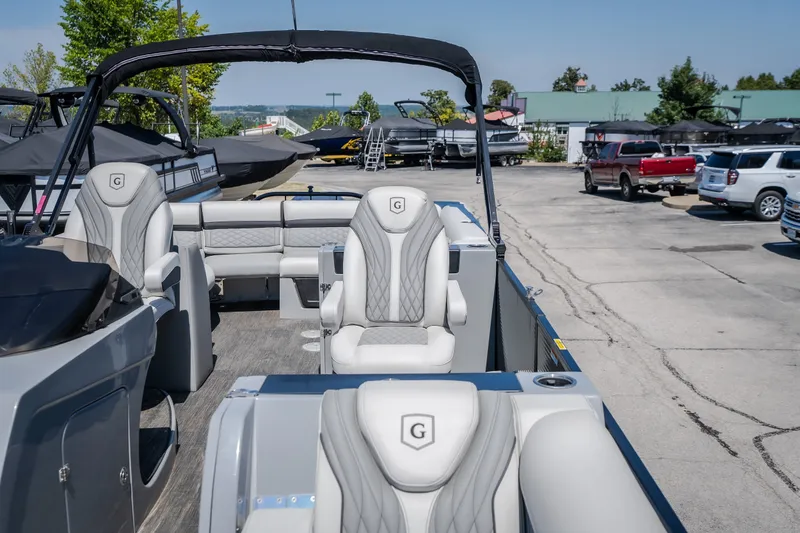 Slide: The Image of 2021 Godfrey Sanpan 2400 ULC pontoon boat with luxurious seating in a marina setting. - 27