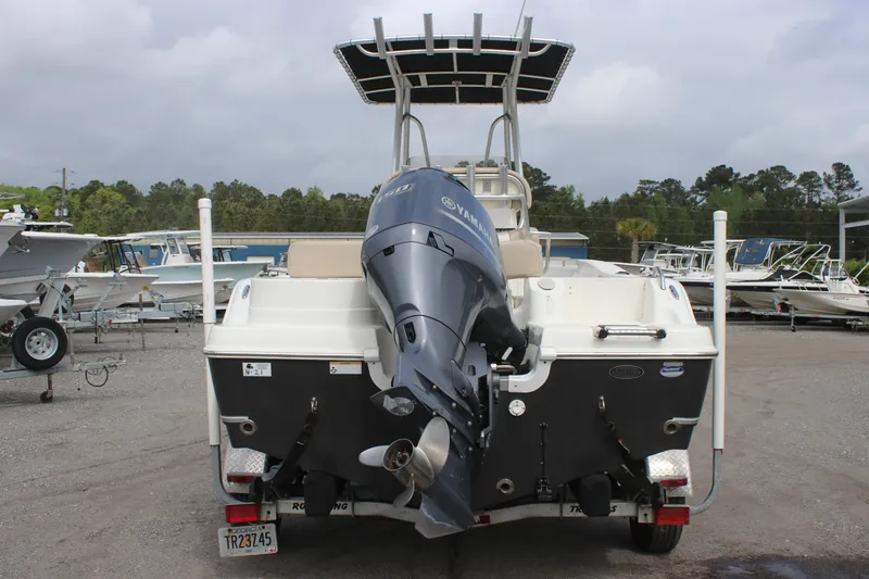 Slide: The Image of 2016 NauticStar 20 XS Offshore boat with outboard motor, docked in a marina. - 13