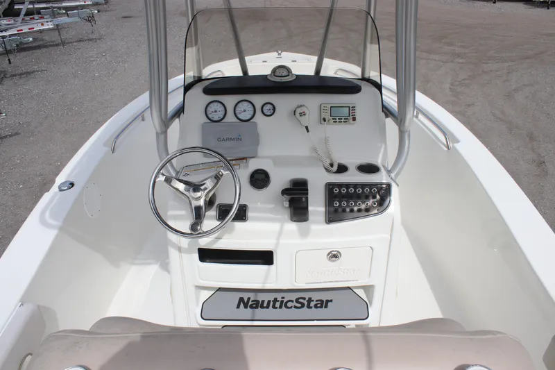 Slide: The Image of 2016 NauticStar 20 XS Offshore boat console with steering wheel and gauges. - 16