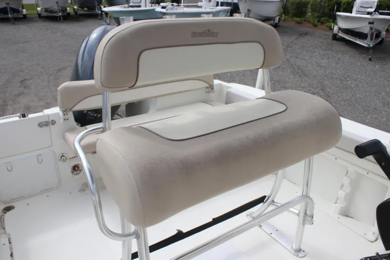 Slide: The Image of 2016 NauticStar 20 XS Offshore boat seating with cushioned backrest. - 17
