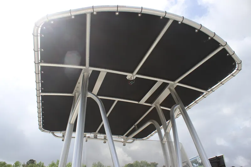 Slide: The Image of 2016 NauticStar 20 XS Offshore boat T-top canopy against cloudy sky. - 21