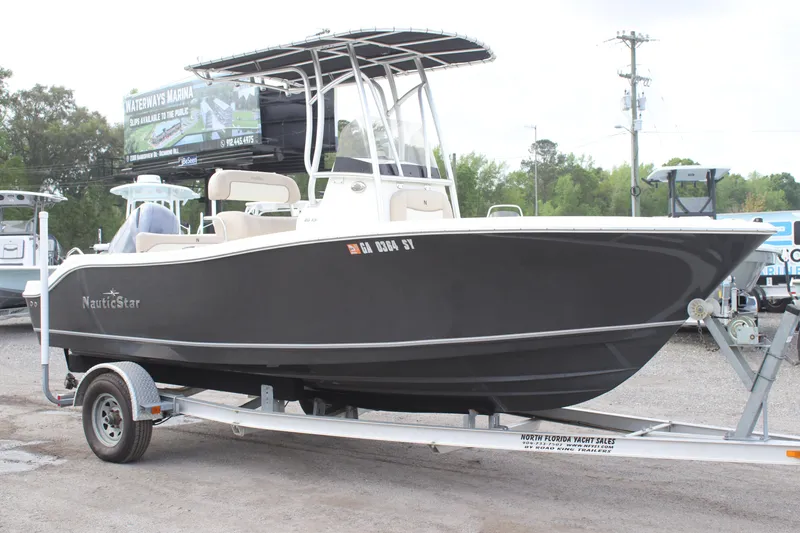 Slide: The Image of 2016 NauticStar 20 XS Offshore boat on trailer in outdoor setting. - 3