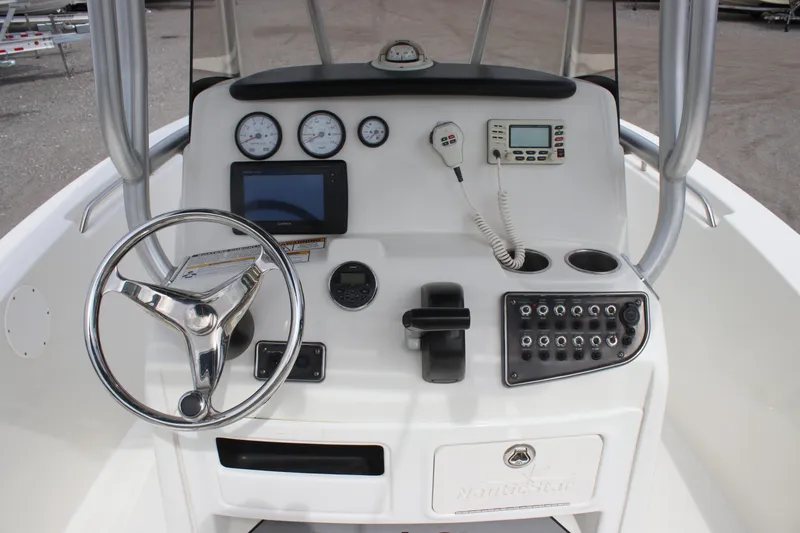 Slide: The Image of 2016 NauticStar 20 XS Offshore boat console with steering wheel and navigation controls. - 9