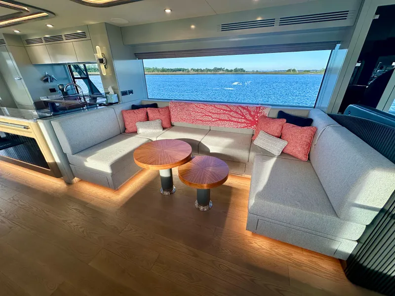 Slide: The Image of Luxurious 2024 Sirena 68 yacht interior with elegant seating and scenic ocean view. - 10