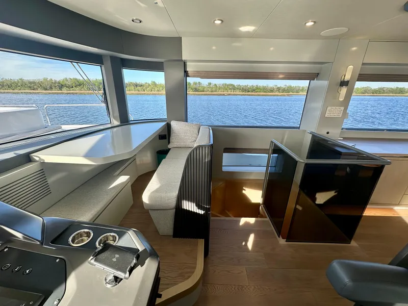 Slide: The Image of Luxurious interior of 2024 Sirena 68 yacht with panoramic windows and modern seating. - 11