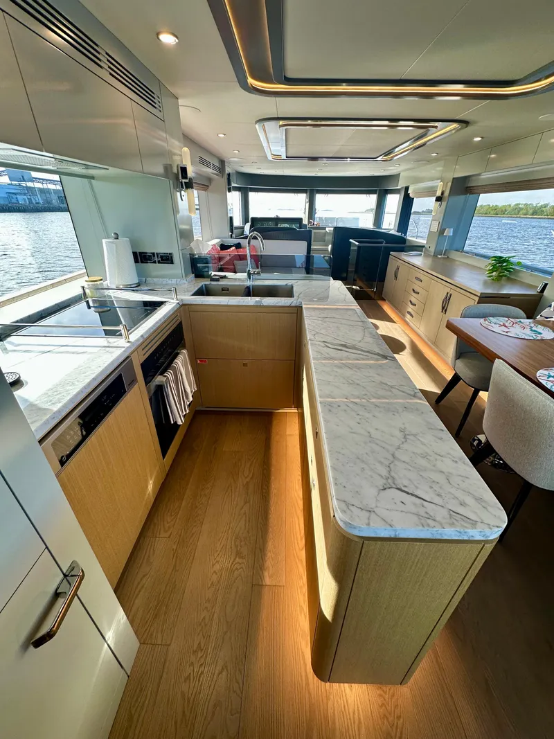 Slide: The Image of Luxurious 2024 Sirena 68 yacht interior with modern kitchen and elegant dining area. - 14