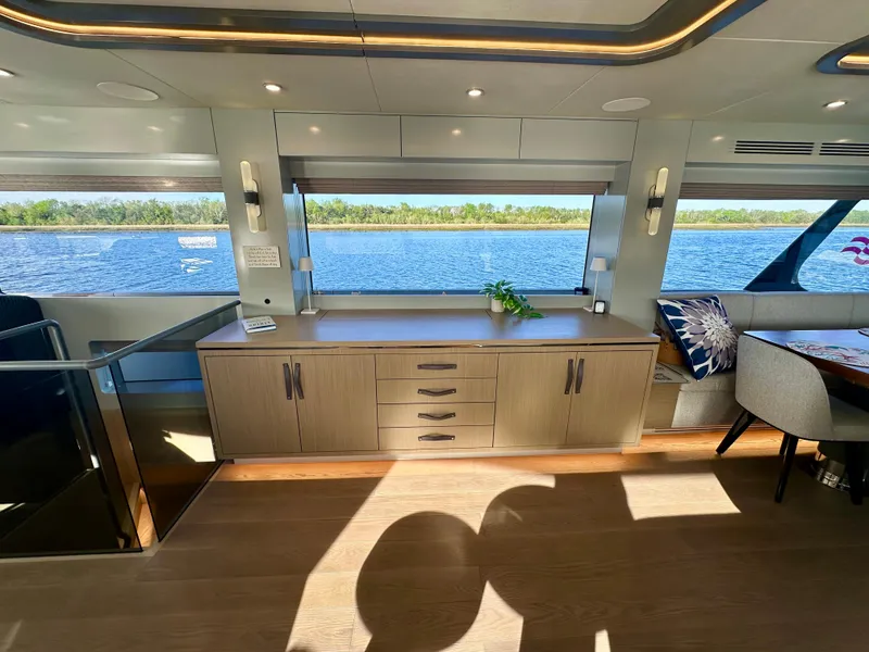 Slide: The Image of Luxurious interior of 2024 Sirena 68 yacht with scenic water view through large windows. - 17