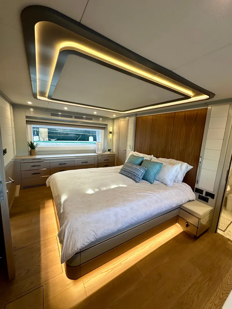 Slide: The Image of Luxurious bedroom interior of 2024 Sirena 68 yacht with modern lighting and elegant decor. - 19