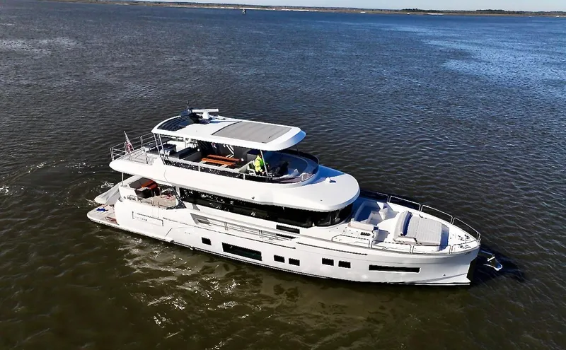 Slide: The Image of 2024 Sirena 68 yacht cruising on open water, showcasing sleek design and luxury features. - 2