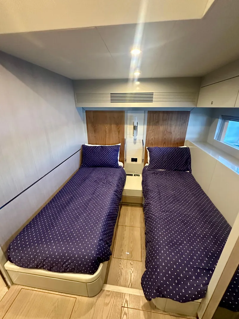 Slide: The Image of 2024 Sirena 68 yacht cabin with twin beds and modern design. - 36