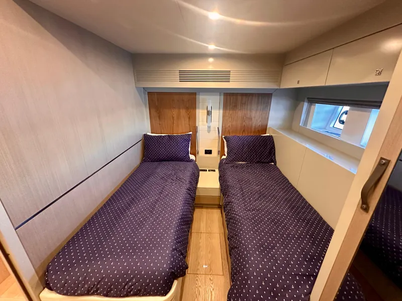 Slide: The Image of Twin cabin interior of 2024 Sirena 68 yacht with modern design and cozy bedding. - 38
